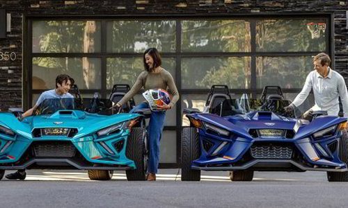 Group of three picking up two Polaris Slingshot rentals with helmets provided